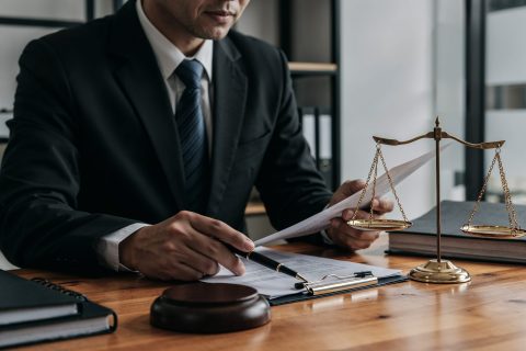 lawyer-working-document-with-scales-justice
