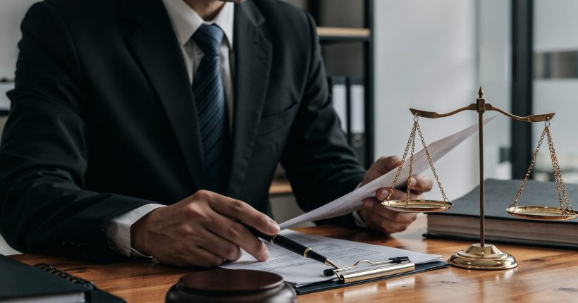 lawyer-working-document-with-scales-justice